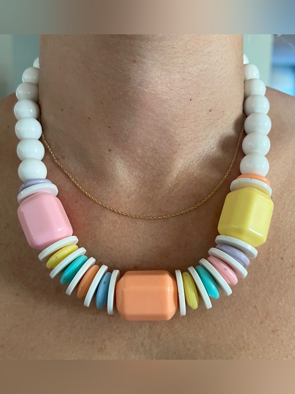 Chunky statement necklace with white round beads and pastel-colored accent beads